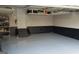 Spacious garage featuring epoxy flooring, shelving, and a convenient entrance to the home at 1007 Oglethorpe Ct, Woodstock, GA 30188