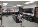 Spacious garage features specialized bicycle rack, televisions, and comfortable seating area at 1007 Oglethorpe Ct, Woodstock, GA 30188