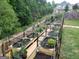 Raised garden planters with gated fence, wood railing and irrigation at 1007 Oglethorpe Ct, Woodstock, GA 30188