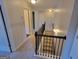 Bright hallway with staircase features neutral colors and access to multiple rooms at 1007 Oglethorpe Ct, Woodstock, GA 30188
