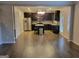 Open kitchen with dark cabinets, stainless appliances, island, and hardwood floors at 1007 Oglethorpe Ct, Woodstock, GA 30188