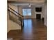 Living room with fireplace, staircase, and hardwood floors at 1007 Oglethorpe Ct, Woodstock, GA 30188