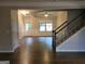 Living room with staircase, hardwood floors and ample natural light at 1007 Oglethorpe Ct, Woodstock, GA 30188
