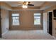 Spacious main bedroom features a tray ceiling, neutral paint, plush carpeting and ample natural light at 1007 Oglethorpe Ct, Woodstock, GA 30188