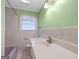 Bright bathroom with a large white countertop and retro purple bathtub at 482 E Lake Rd, Mcdonough, GA 30252