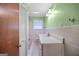 Bathroom with a white vanity and vintage fixtures at 482 E Lake Rd, Mcdonough, GA 30252