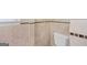 A clean bathroom featuring beige tile walls accented by decorative brown mosaic trim and a toilet at 482 E Lake Rd, Mcdonough, GA 30252