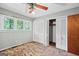 Spacious bedroom with light-filled windows, ceiling fan, and ample closet space at 482 E Lake Rd, Mcdonough, GA 30252