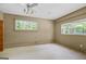 Bright bedroom with two windows, ceiling fan, and neutral walls at 482 E Lake Rd, Mcdonough, GA 30252