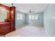 Bedroom with built-in shelving, drawers, natural light, and neutral carpet at 482 E Lake Rd, Mcdonough, GA 30252