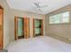 Bedroom featuring built-in closets with slat doors and natural light from the window at 482 E Lake Rd, Mcdonough, GA 30252