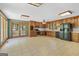 Spacious kitchen with wood cabinets, neutral countertops, tile floors, and stainless steel appliances at 482 E Lake Rd, Mcdonough, GA 30252