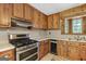 Kitchen featuring stainless steel appliances, tile flooring, and wood cabinets at 482 E Lake Rd, Mcdonough, GA 30252
