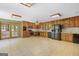 Spacious kitchen with wood cabinets, neutral countertops, tile floors, and stainless steel appliances at 482 E Lake Rd, Mcdonough, GA 30252