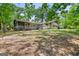Spacious backyard featuring a screened-in porch and mature trees, perfect for outdoor entertaining and relaxation at 482 E Lake Rd, Mcdonough, GA 30252