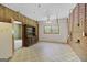 Room featuring unique tile flooring, brick accent wall, wood paneling, and natural light at 482 E Lake Rd, Mcdonough, GA 30252