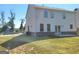 Spacious backyard featuring a green lawn and rear view of home's exterior at 502 Hinton Farm Way, Dacula, GA 30019