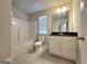 Well-lit bathroom features a shower-tub, toilet, vanity, and mirror at 502 Hinton Farm Way, Dacula, GA 30019