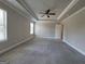 Carpeted main bedroom showcasing tray ceilings and neutral paint at 502 Hinton Farm Way, Dacula, GA 30019