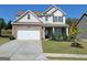 Charming two-story home featuring a stone facade, manicured lawn, and a two-car garage at 502 Hinton Farm Way, Dacula, GA 30019