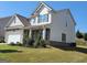 Charming two-story home with white siding, stone accents, and well-maintained landscaping at 502 Hinton Farm Way, Dacula, GA 30019