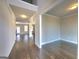 Open hallway with hardwood floors leading to various rooms of the home at 502 Hinton Farm Way, Dacula, GA 30019