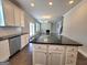 Open concept kitchen with island, stainless steel appliances, and view into the living room at 502 Hinton Farm Way, Dacula, GA 30019