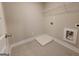 Neat laundry room with tile floors, and hookups for washer and dryer at 502 Hinton Farm Way, Dacula, GA 30019