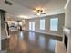Expansive open-concept living space features hardwood floors, a fireplace, and a modern kitchen at 502 Hinton Farm Way, Dacula, GA 30019