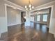 Open-concept living area with hardwood floors and elegant trim details at 502 Hinton Farm Way, Dacula, GA 30019