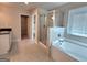 Bathroom featuring tiled shower, soaking tub and granite counters at 502 Hinton Farm Way, Dacula, GA 30019