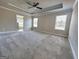 Spacious main bedroom with tray ceilings and view to the main bath at 502 Hinton Farm Way, Dacula, GA 30019