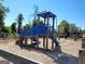 Community playground with blue playset, mulch ground cover, and wooden fence at 502 Hinton Farm Way, Dacula, GA 30019