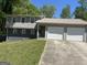 Split-level home with attached two-car garage and a concrete driveway at 9503 Winding Way Ln, Jonesboro, GA 30238