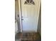 Close-up of a white front door with welcome mat on covered porch at 9503 Winding Way Ln, Jonesboro, GA 30238