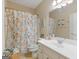 Bathroom featuring a white vanity, large mirror, and a shower with a floral curtain at 225 Suffolk Way, Mcdonough, GA 30252