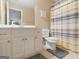 This bathroom features tile flooring, white vanity, and a large mirror at 225 Suffolk Way, Mcdonough, GA 30252