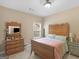 Bedroom featuring a wooden bed frame with a nightstand and dresser at 225 Suffolk Way, Mcdonough, GA 30252