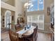Dining room with large windows, chandelier, hardwood floors, and access to the foyer at 225 Suffolk Way, Mcdonough, GA 30252