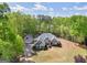 Inviting home with lush landscaping, a detached garage, and gray paint at 225 Suffolk Way, Mcdonough, GA 30252