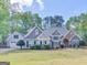 Charming two-story home featuring a well-manicured lawn and craftsman-style details at 225 Suffolk Way, Mcdonough, GA 30252