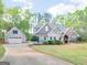 Beautiful craftsman-style home with lush landscaping, attached garage, and long driveway at 225 Suffolk Way, Mcdonough, GA 30252