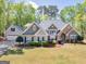 Charming home with a manicured front lawn, mature trees, and welcoming curb appeal at 225 Suffolk Way, Mcdonough, GA 30252