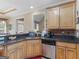 Kitchen featuring granite countertops, wood cabinets, and stainless steel appliances at 225 Suffolk Way, Mcdonough, GA 30252