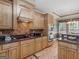 Bright kitchen featuring wood cabinets, tiled backsplash, granite countertops and stainless steel appliances at 225 Suffolk Way, Mcdonough, GA 30252