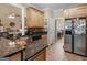 Well-lit kitchen featuring granite countertops, stainless steel appliances, and wood flooring at 225 Suffolk Way, Mcdonough, GA 30252