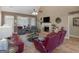 Spacious living room with hardwood floors, a fireplace, and access to the outdoors at 225 Suffolk Way, Mcdonough, GA 30252