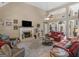 Open concept living room with fireplace, high ceilings, and hardwood floors at 225 Suffolk Way, Mcdonough, GA 30252