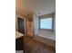 Bright bathroom showcases a tub, shower and large window for natural lighting at 403 Buckboard Ln, Locust Grove, GA 30248