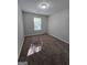 Neutral bedroom with a window, neutral walls, and carpet flooring at 403 Buckboard Ln, Locust Grove, GA 30248